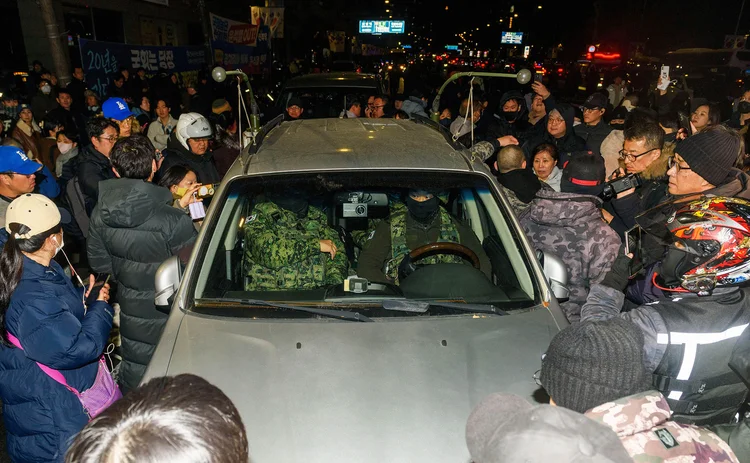 People blocking martial law military vehicles in front of the National Assembly, Seoul, December 4, 2024